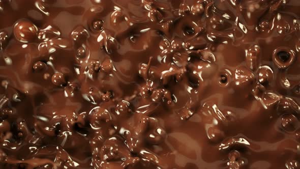 Super Slow Motion Detail Shot of Splashing Melted Chocolate at 1000 Fps alt