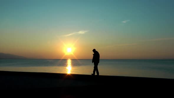 Lonely Man Smoke Cigarettes and Walking near the Seaside alt