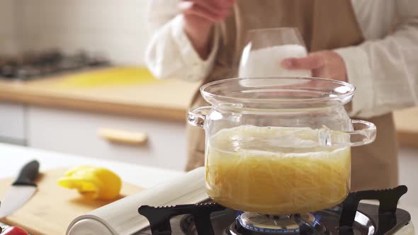 The Cook Salts The Cooked Spaghetti Pasta In Italian, Throws Salt Into The Food Bowl. Cooking Pasta alt
