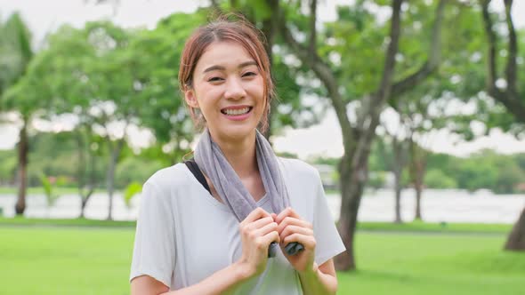 Asian active sport woman stand with confidence after exercise outdoors. alt
