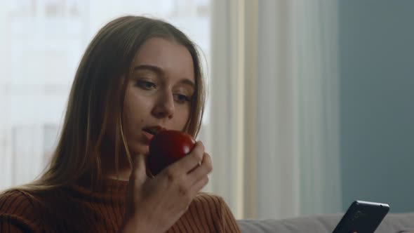 Pretty Woman Bites Red Apple