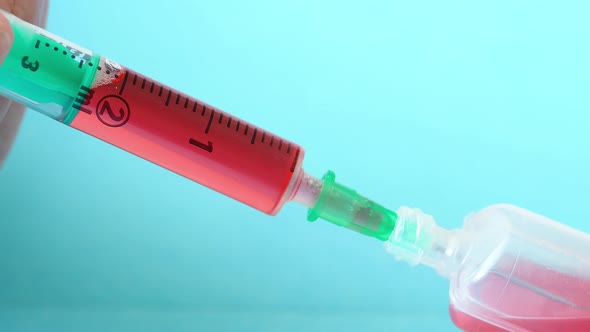 Plastic medical syringe with needle and plastic vial. Medical injection concept.