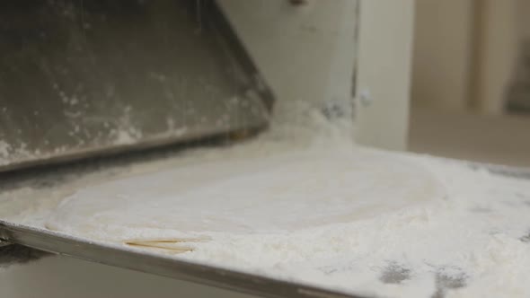 The Gloved Hands of the Baker Rub Flour Onto Each Cake Before Baking