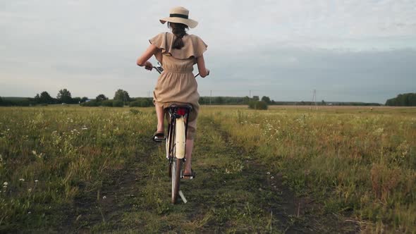A Woman Rides a Retro Bike