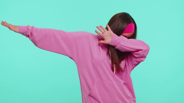 Trendy Cheerful Girl Dancing and Moving to Rhythm Dabbing Raising Hands Making Dubdance Gesture alt