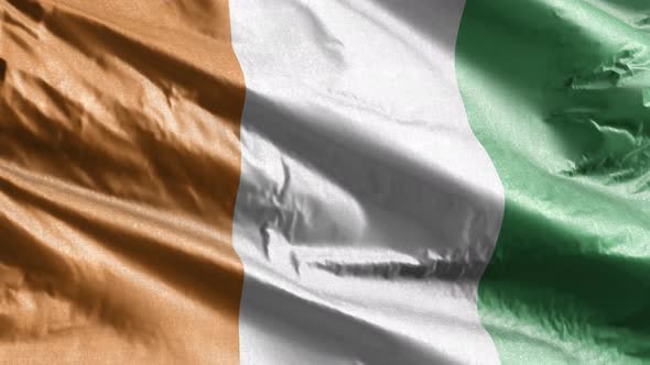 Cote D'lvoire textile flag waving on the wind. Slow motion. 20 seconds loop. 