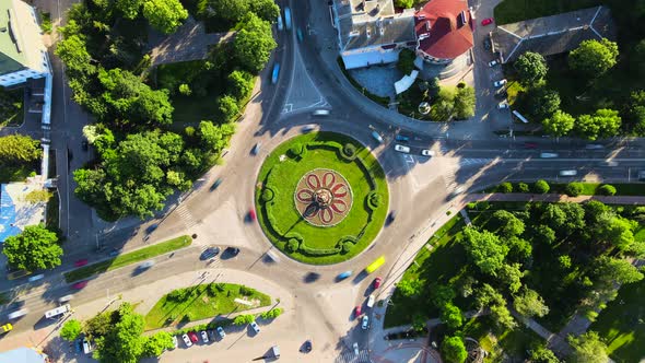 Aerial View Timelapse of Roundabout Road with Circular Cars in Small European City at Sunny Summer alt