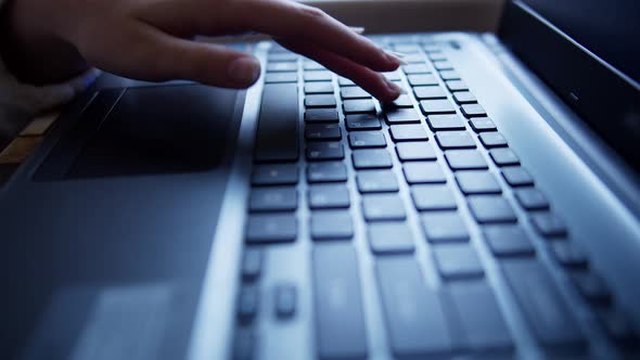 Teen girl learning to type on a laptop keyboard, close-up, rack focus alt