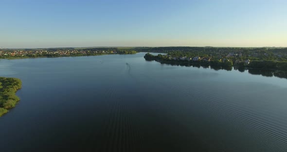 The boat floats on the river, beautiful stains on the water alt