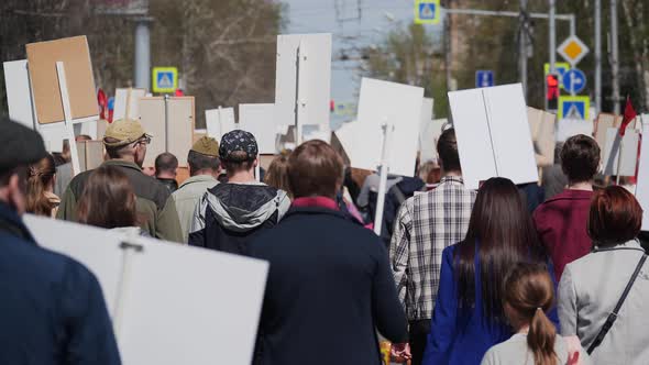 Angry People in Banners on City Street alt