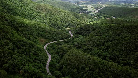 Logistic concept aerial view of countryside road - motorway passing through the serene lush greenery alt