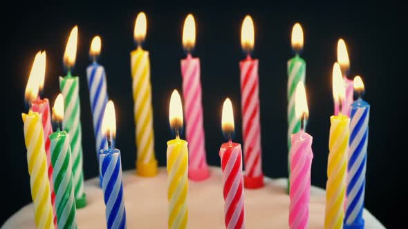 Birthday Candles On Cake Are Blown Out With Wispy Smoke alt