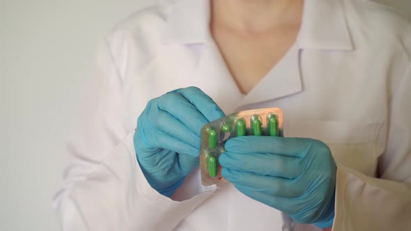 The Doctor Takes a Pill From the Blister alt