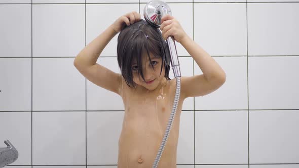 Boy Child 5 Years Old Brunette with Long Hair Washes in the Bathroom and Sings alt