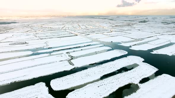 Aerial view of marshland covered with snow in The Netherlands. alt