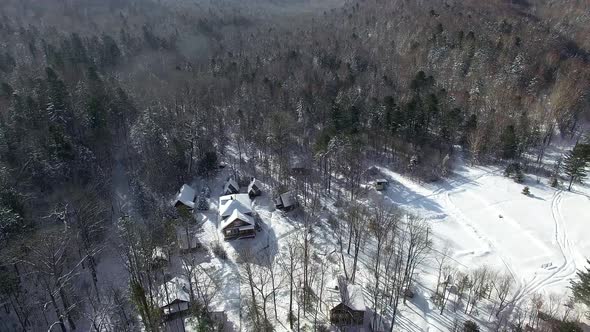 Several Houses in the Middle of the Winter Taiga Frome Drone alt