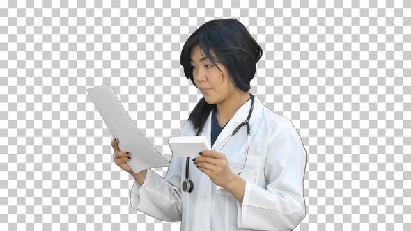 Asian female doctor reading prescription, Alpha Channel