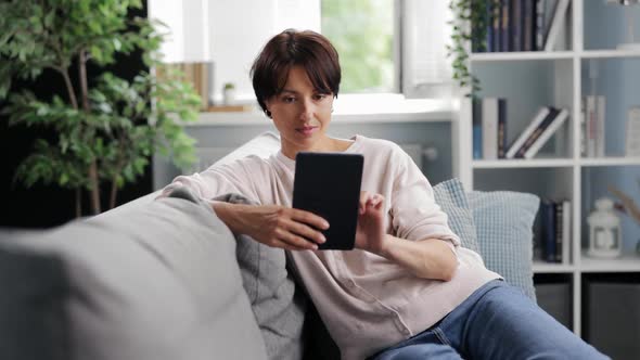 Woman Using Tablet at Home