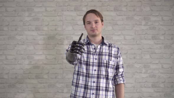 Positive Young Man Shows Thumbs Up Bionic Prosthetic Hand alt