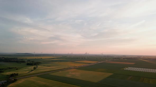 Windmill Turbines at Sunset Wind Energy Concept alt