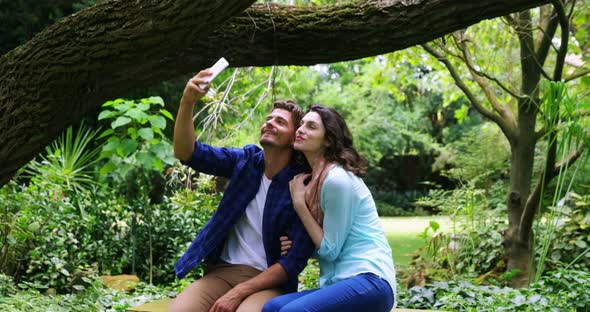 Romantic couple taking selfie from mobile phone alt