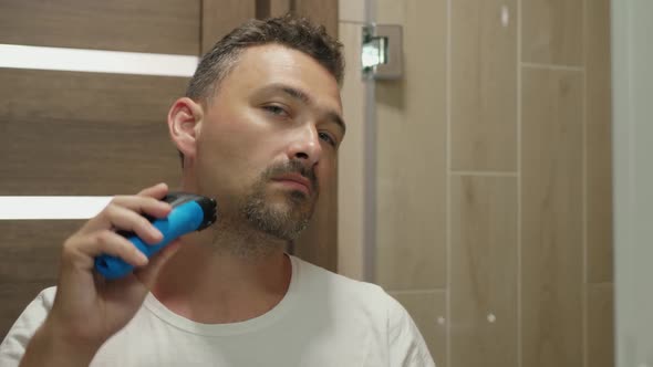 Man Shaves His Cheek