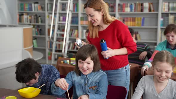 Woman Teacher Adding Shaving Foam for Slimes alt