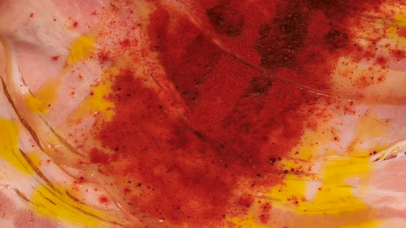 Macro shot of red pepper powder on ham and olive oil combination. Close up shot of red spice sprinkl alt