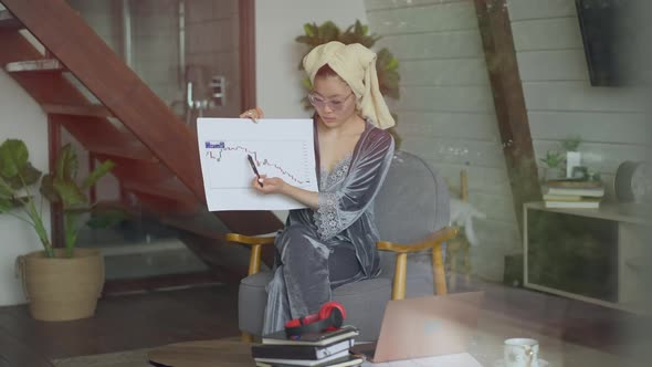Focused Asian Woman Pointing at Business Graph Discussing Strategy Idea Online in Virtual Conference alt