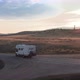 Drone Follows Camper Van Rv From the Back It Sunset on Road in Wilderness - VideoHive Item for Sale