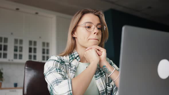 Young Woman Designer Video Chatting with Client Via Laptop Discussing Project Details Showing Color alt
