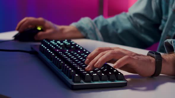 Closeup on Hands Man Gamer Playing in Video Game Using Keyboard alt