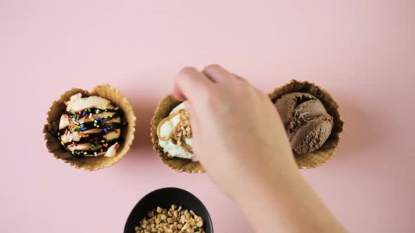 Waffle ice cream bowls with scoops of ice cream on a pink background. alt