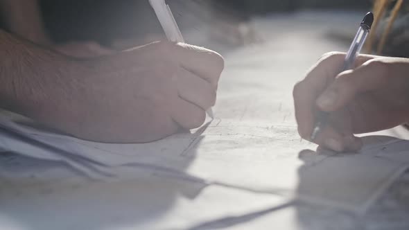 Closeup Of Person's Engineer Hand Drawing Plan On Print with Architect Equipment alt