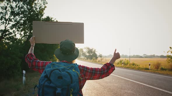 Woman Tourist Trying to Catch Car on Country Road Back View Slow Motion alt