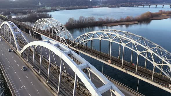 Automobile and Railroad Darnitsky Bridge Aross Dnieper River from Above Kiev City Skyline alt