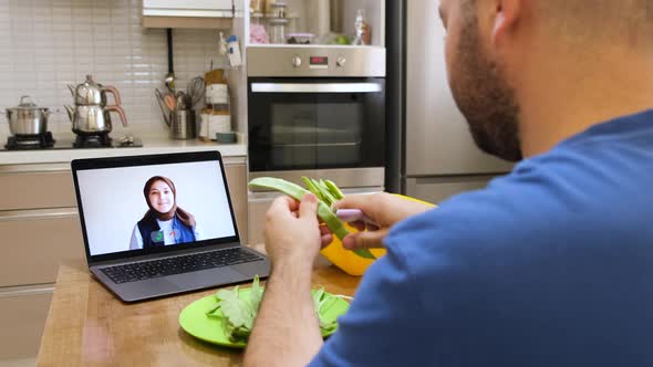 She is talking to her Muslim sister, who wears a headscarf, via videoconference.