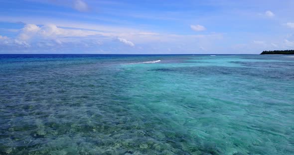 Wide aerial island view of a sandy white paradise beach and blue water background  alt