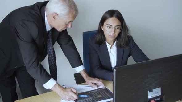 Focused Experienced Professional Explaining Graph Details alt