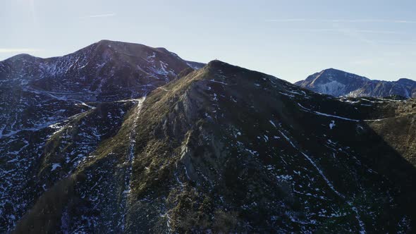 Aerial, Alps Mountains Partially Covered With Snow In Italy