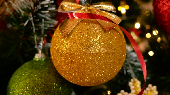 Christmas Golden Ball Decoration on Xmas Tree alt