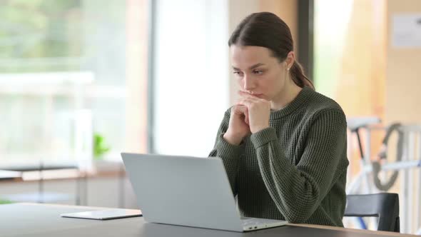 Pensive Woman Thinking at Work Brainstorming alt