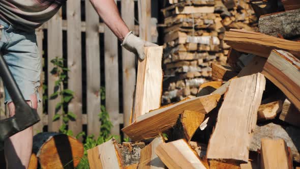 Strong Male Worker Chopping Wood Swinging and Hitting Wooden Log with Axe alt