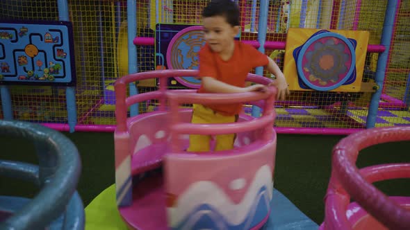 A Little Boy Circles Himself on a Carousel