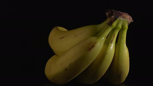 Closeup Shot of Wet Bananas on a Turntable with a Black Background
