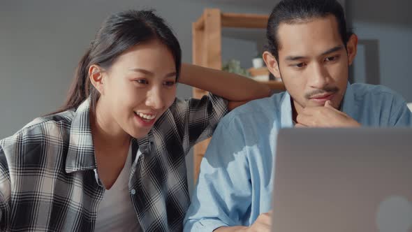 couple man and woman thrilled excited maready bank loan agreement for new house online in laptop.