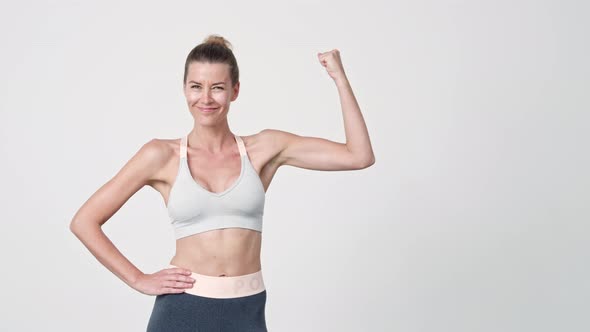 Sportswoman Flexing Biceps to Camera