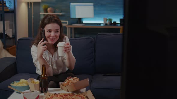 Caucasian Adult Enjoying Phone Call with Friend in Living Room alt