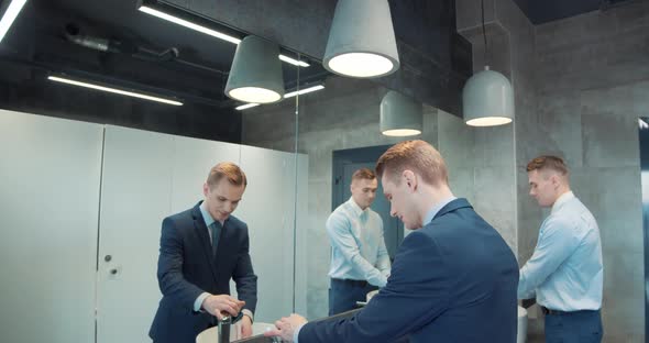 Two Business Man in Office Bathroom alt