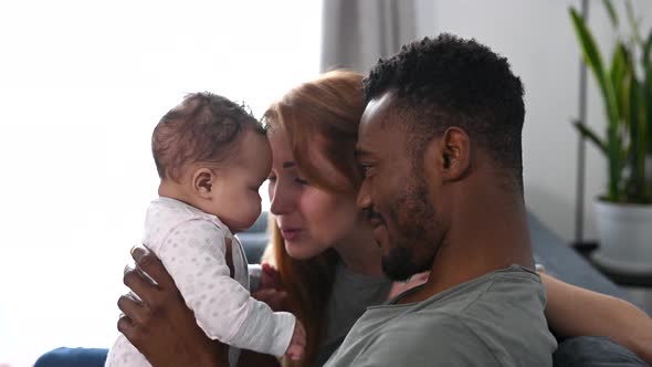 A Happy Multiracial Family of Three at Home alt